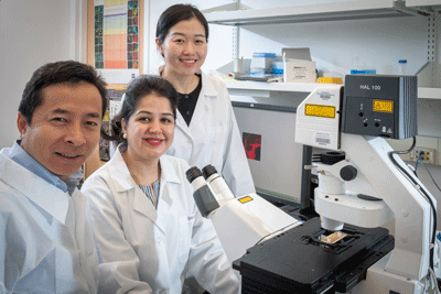 professor and student researchers at their lab