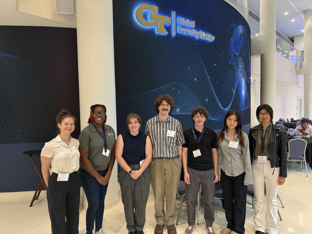Six students pose together at Georgia Tech’s Global Learning Center during an indoor event.